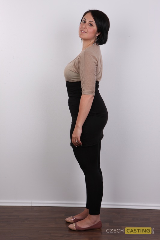 Chubby brunette removes yoga pants before sitting naked on a stool