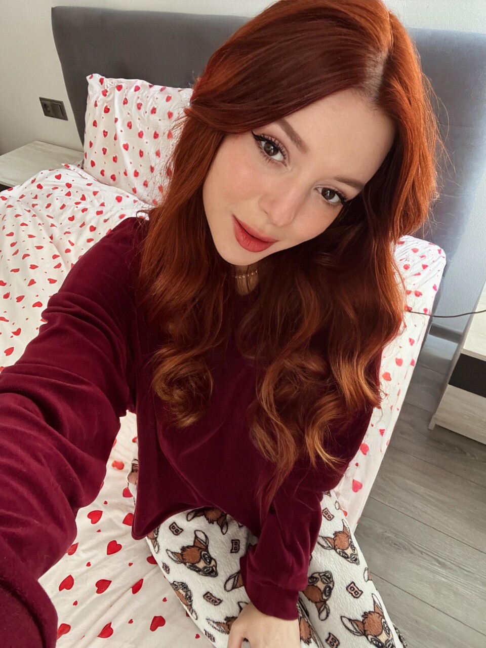 Adorable redheaded teen Sofi Foxxxy squeezes her lovely big tits on a bed