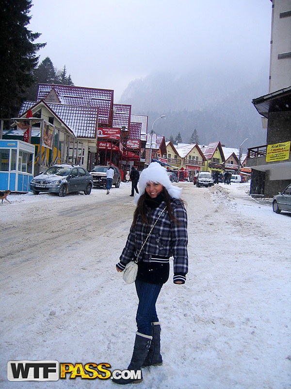 Amateur couple takes self shots while visiting a snow covered town