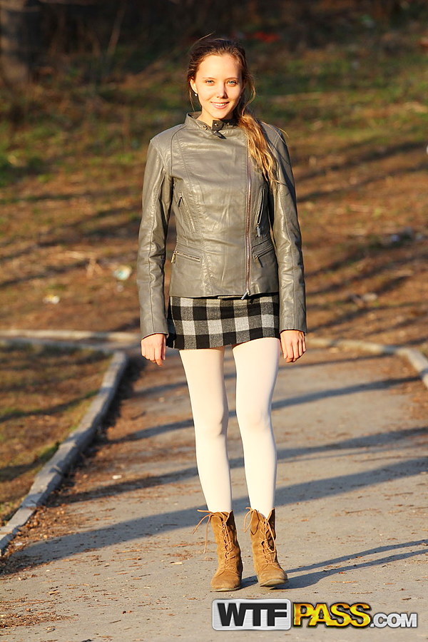 Hot teen undoes her leather jacket while walking outdoors by herself