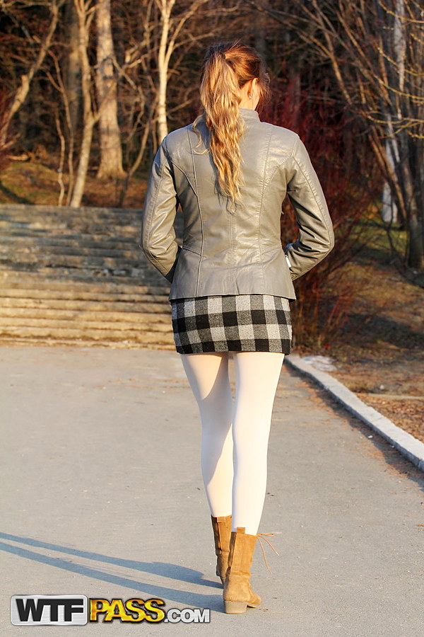 Hot teen undoes her leather jacket while walking outdoors by herself
