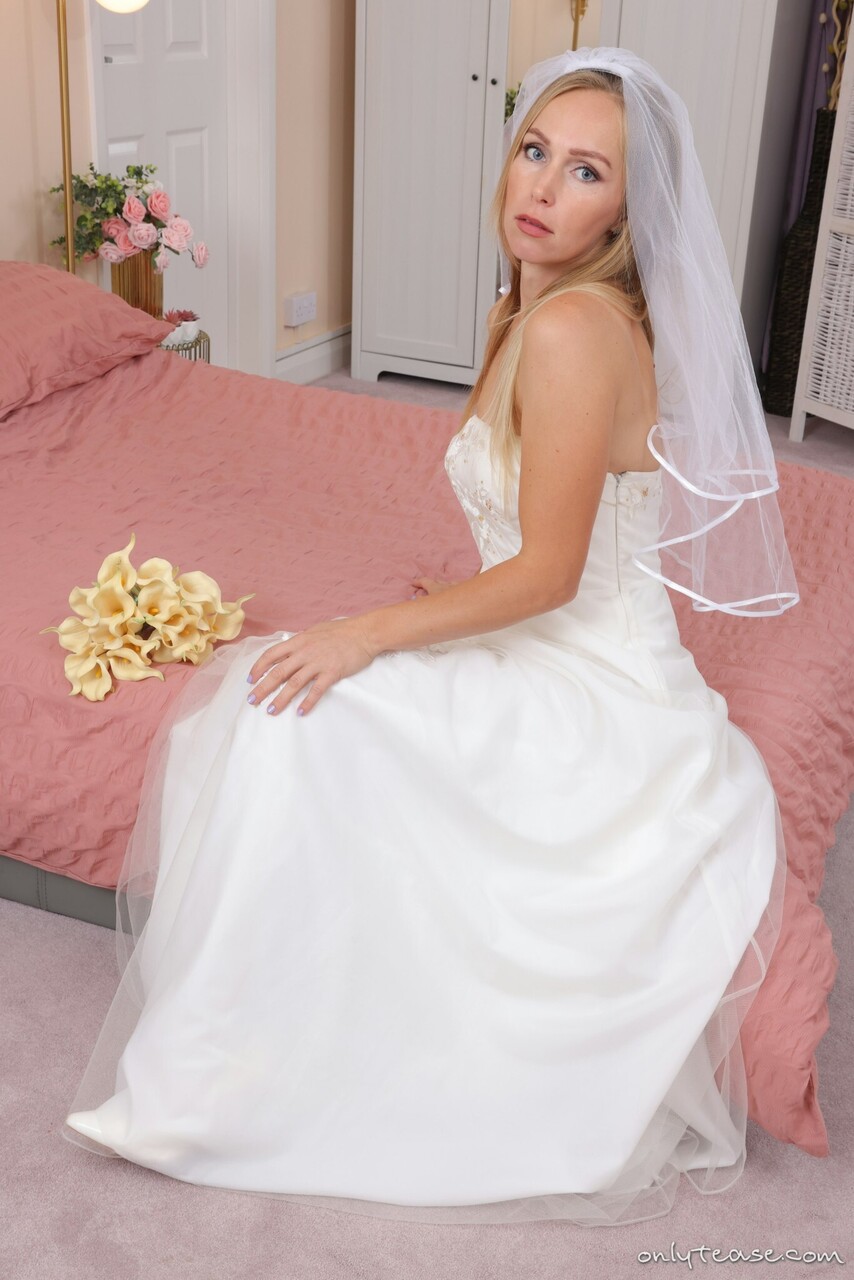 Blonde bride Anabel takes off her wedding dress in a teasing manner