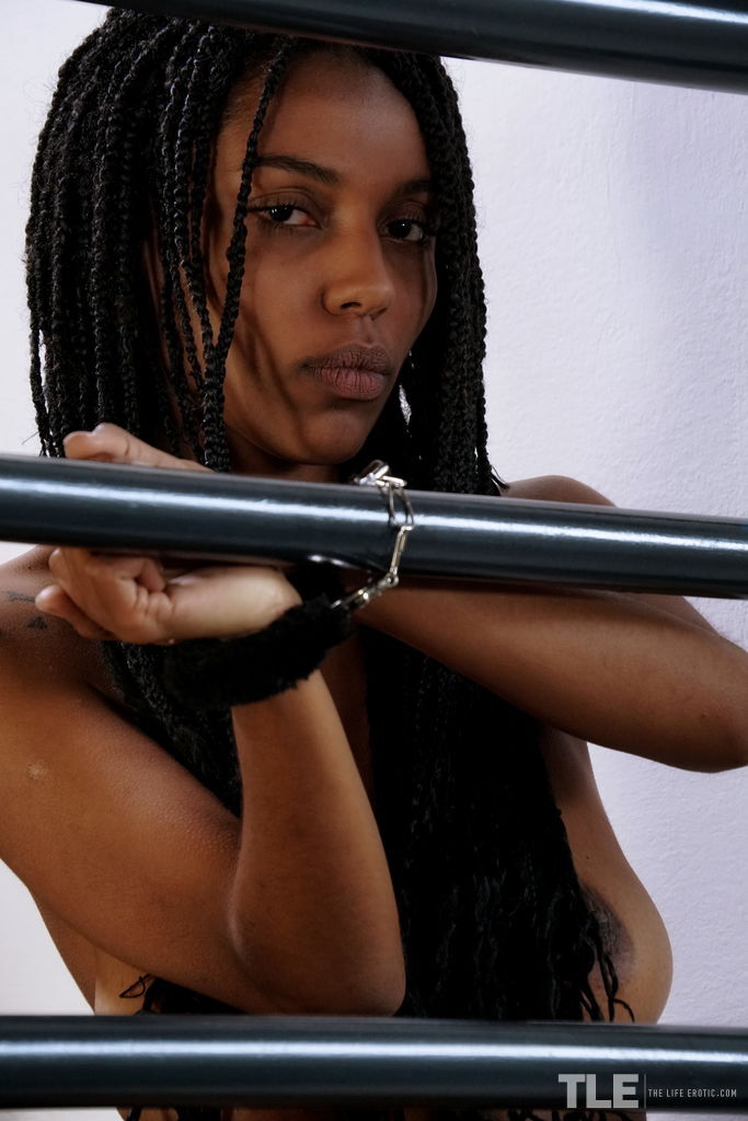 Black teen with braided hair sticks a feather in her shaved pussy