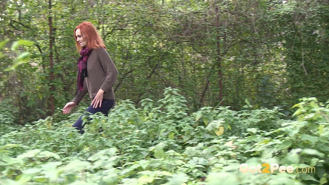 Skinny redhead Liza ducks into the bushes for an urgent piss