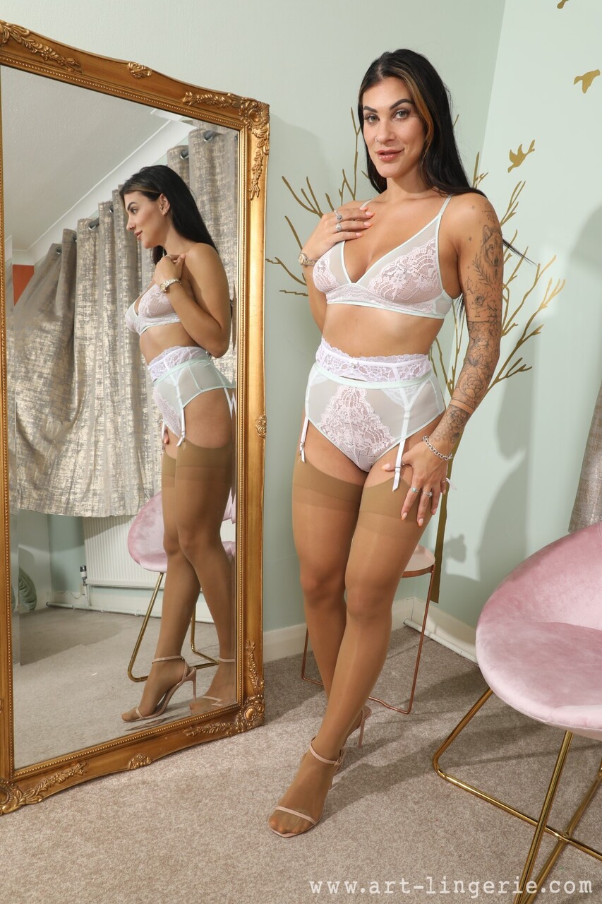 British model Roxy Mendez uncovers her firm tits in tan nylons and heels
