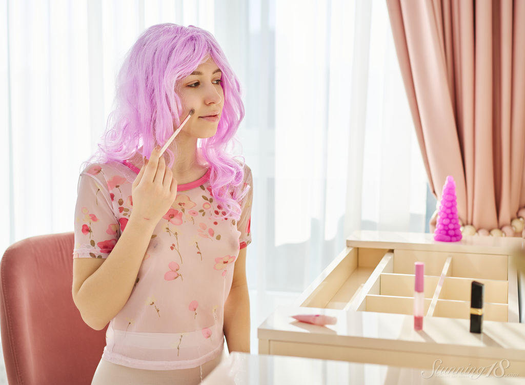 Cute teen Adele sports a pink wig while getting naked to masturbate