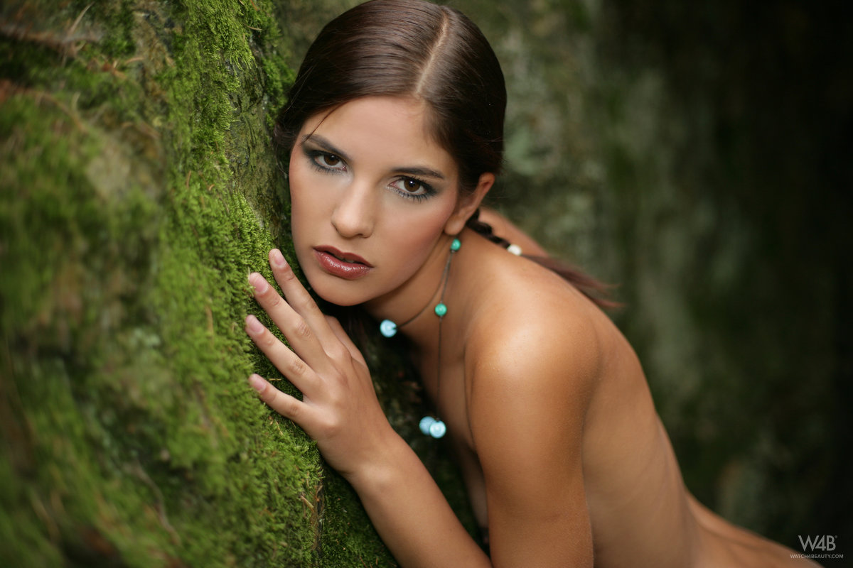 Skinny teen with a tight ass models completely nude while wandering a forest