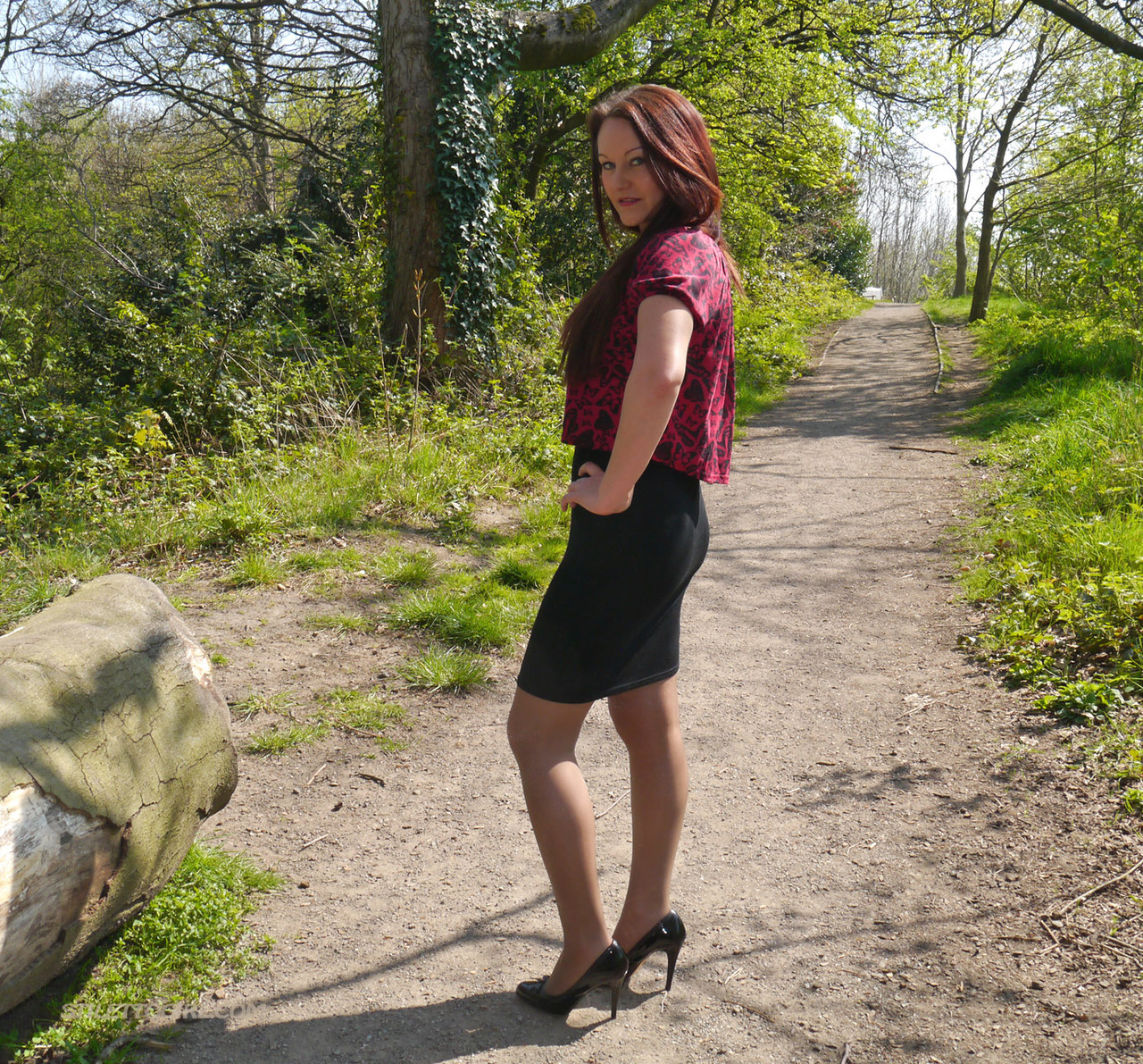 Clothed female models in black pumps and sheer stockings on a dirt path