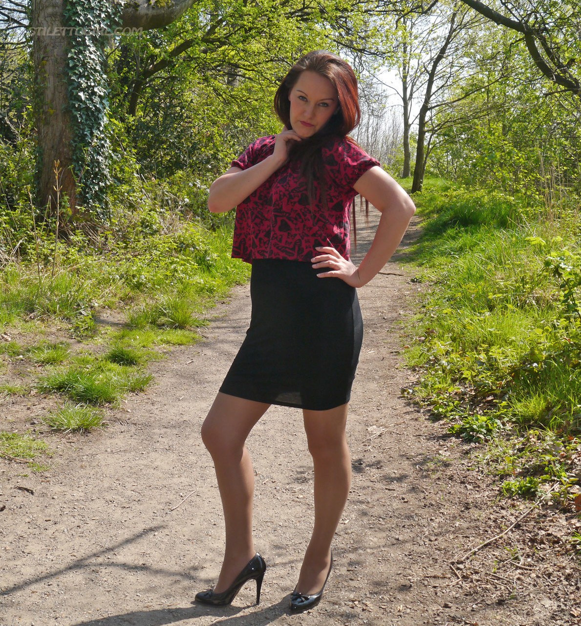 Clothed female models in black pumps and sheer stockings on a dirt path