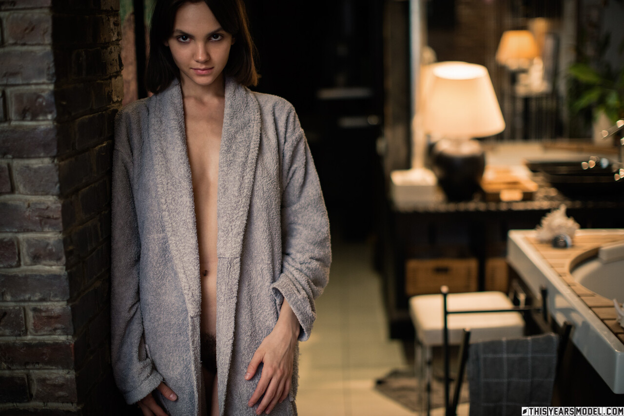 Beautiful brunette Lara Masier gets naked in a robe while in a bathroom