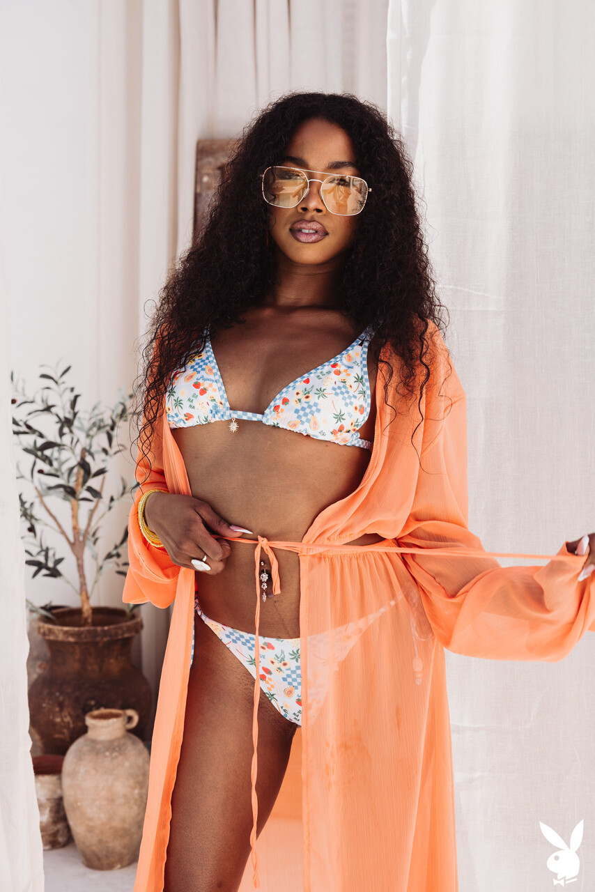 Sexy black girl with curly hair gets naked in a confident manner