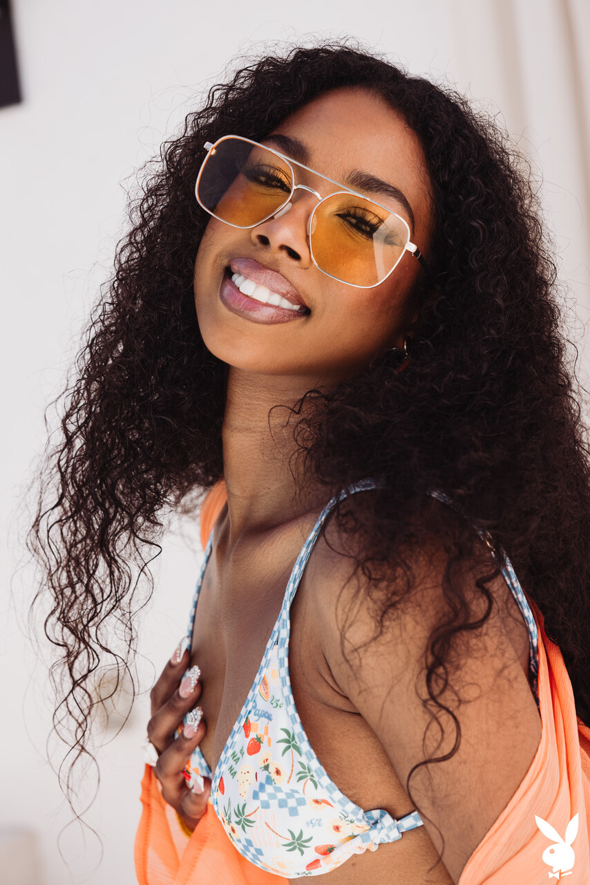 Sexy black girl with curly hair gets naked in a confident manner
