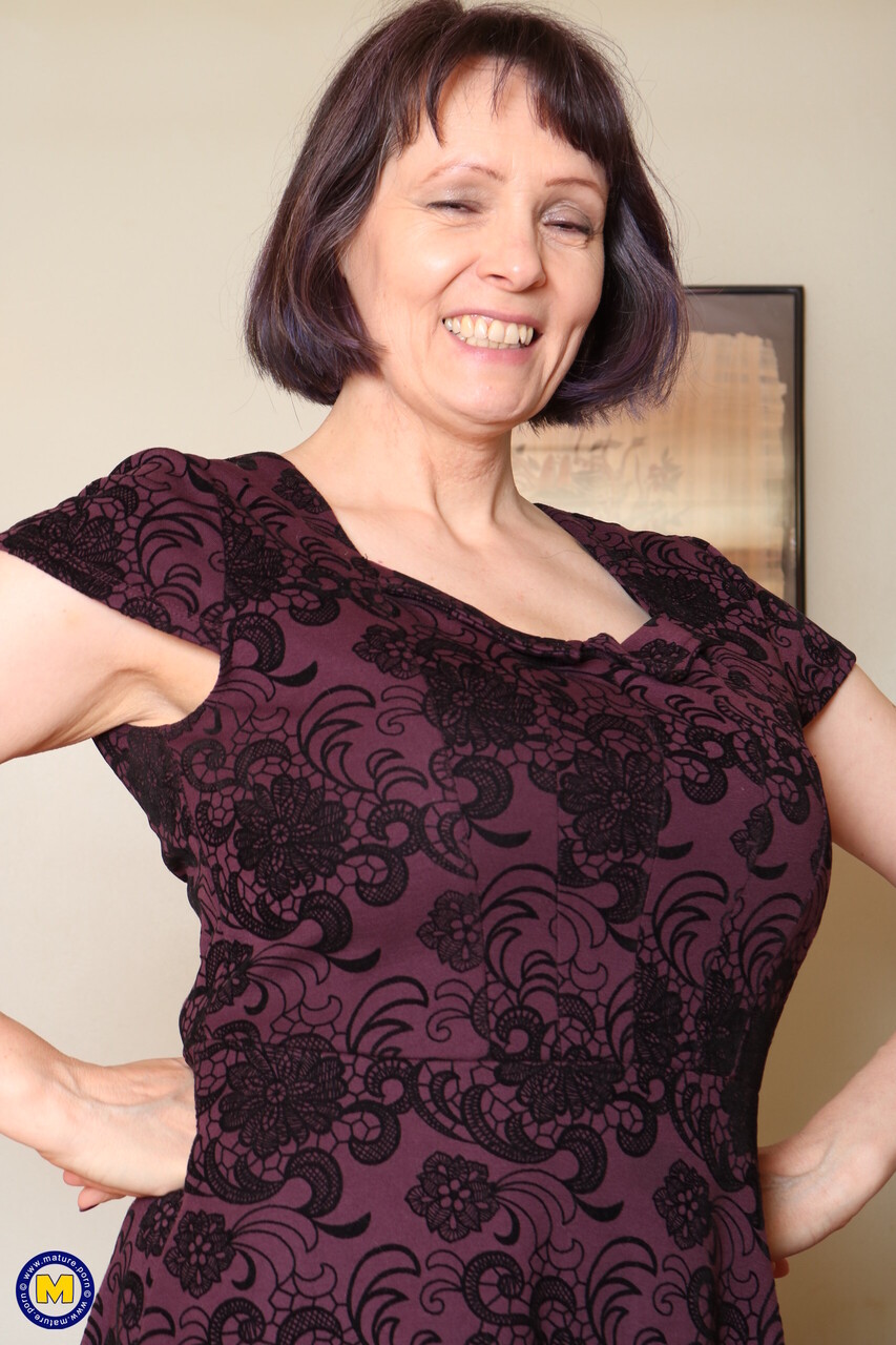 Mature woman with firm breasts displays her bald snatch in sheer stockings