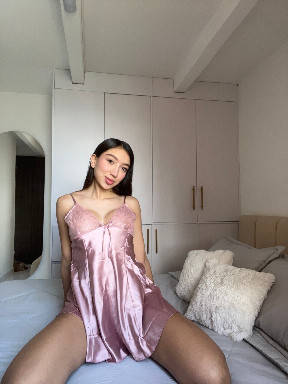 Beautiful brunette shows her hot ass in satin lingerie during a non-nude shoot