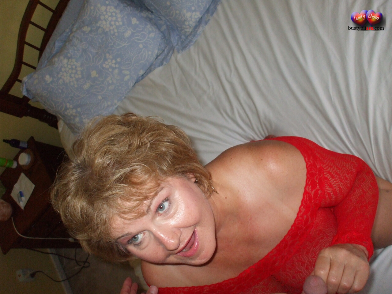 Mature lady Busty Bliss plays with a cock while showing her tits and pussy