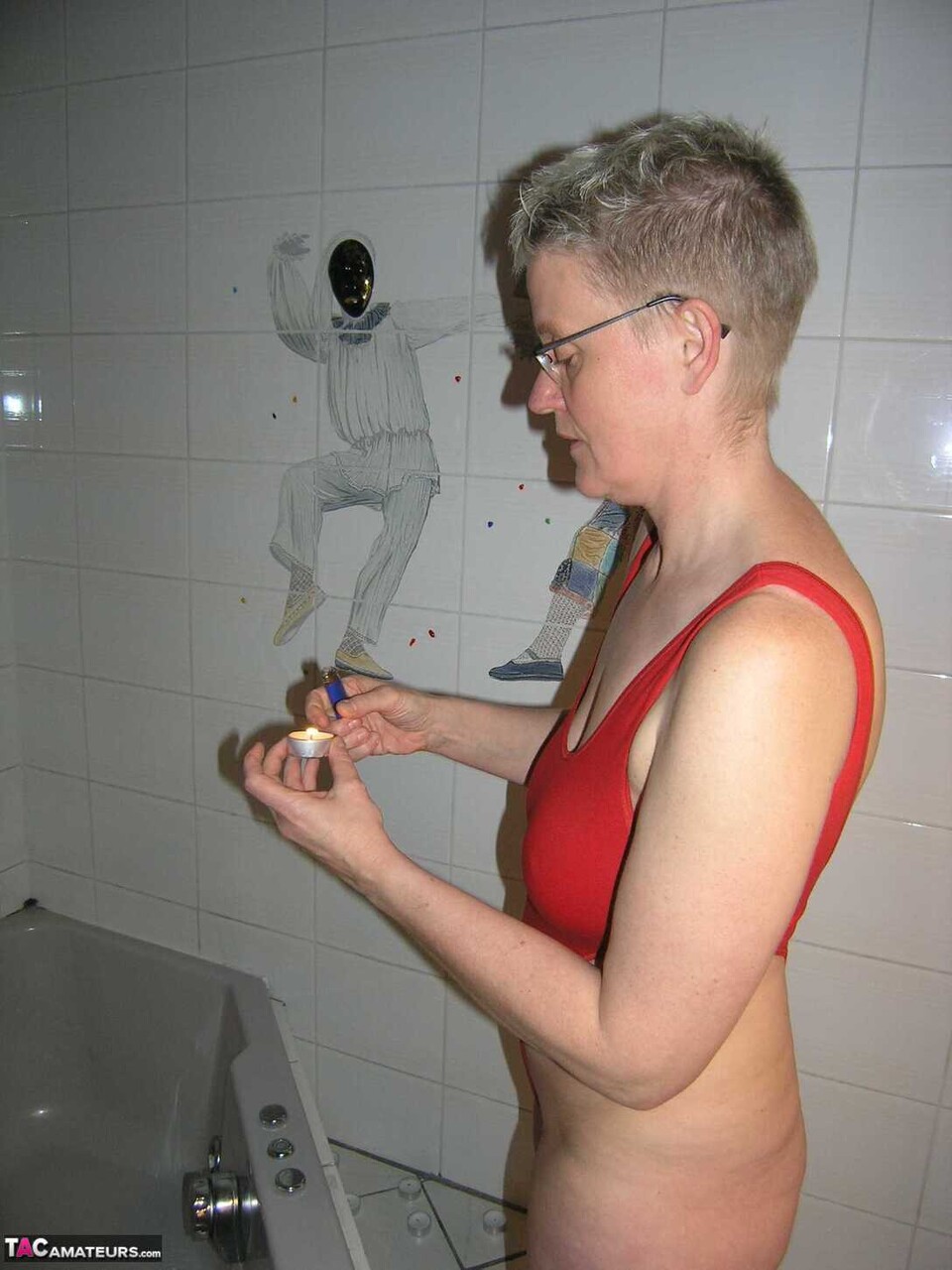 Mature amateur Tiffany Pearl takes a bath while wearing glasses and a red swimsu