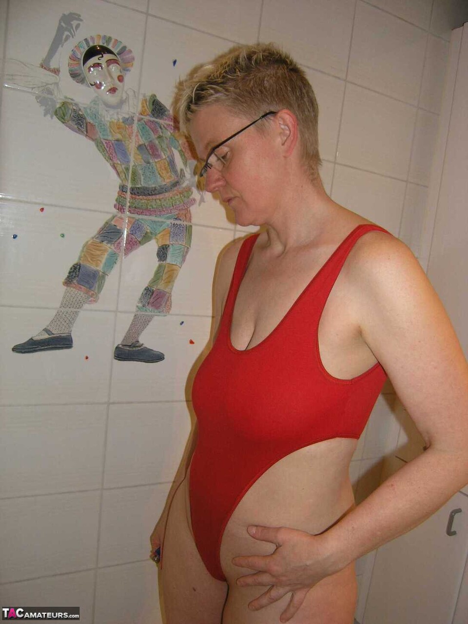 Mature amateur Tiffany Pearl takes a bath while wearing glasses and a red swimsu