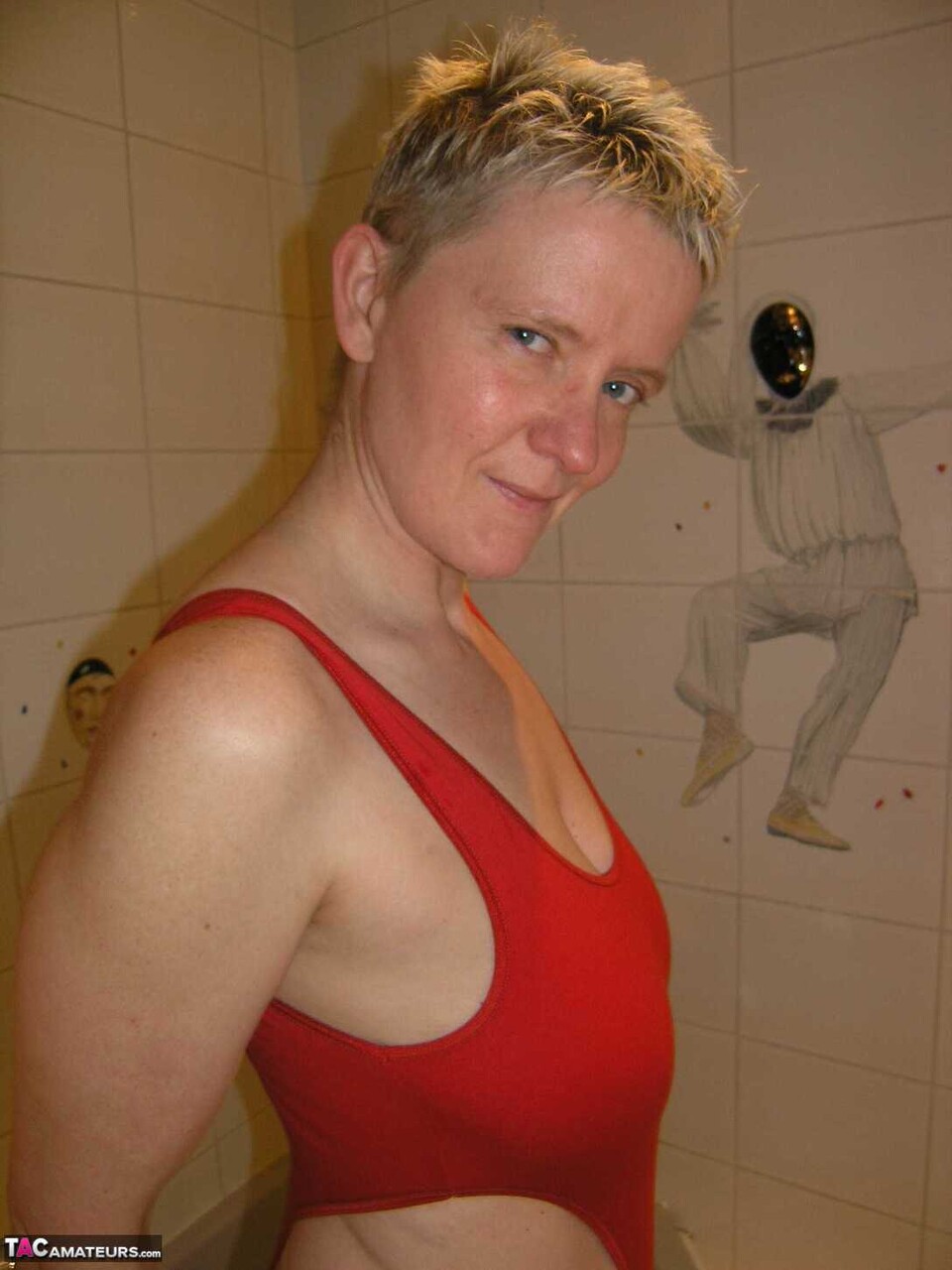Mature amateur Tiffany Pearl takes a bath while wearing glasses and a red swimsu