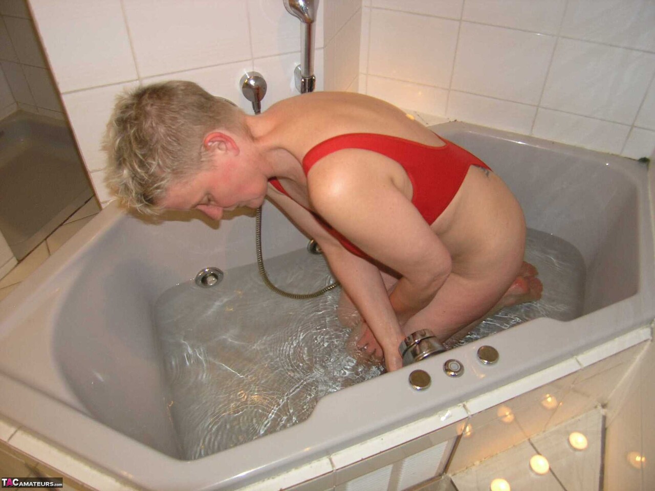Mature amateur Tiffany Pearl takes a bath while wearing glasses and a red swimsu