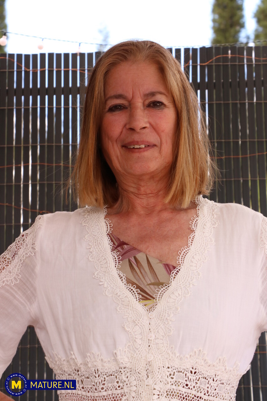 Old woman shows her natural tits and twat on a patio during solo action