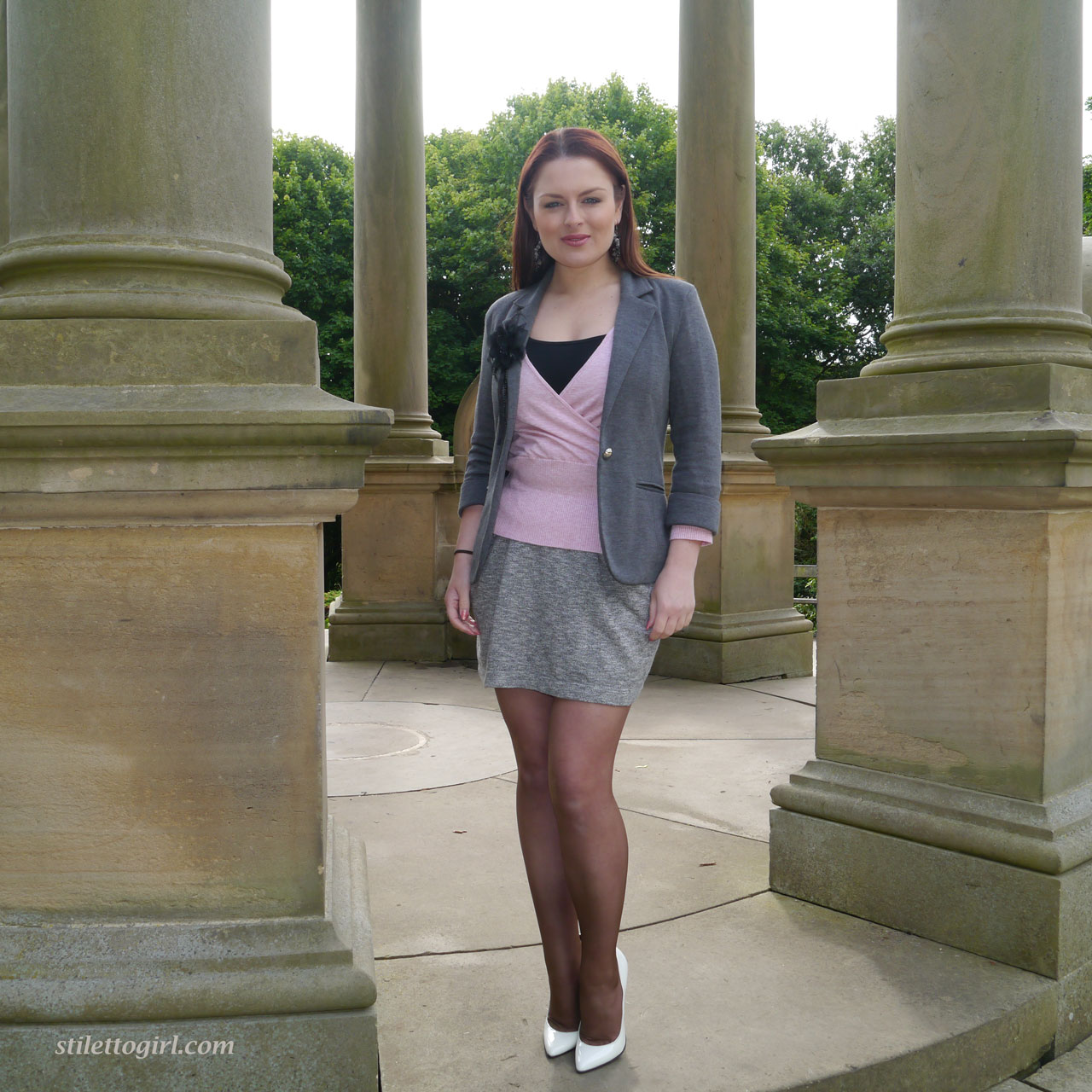 Redhead model showcases her hot legs in a short skirt and high heels