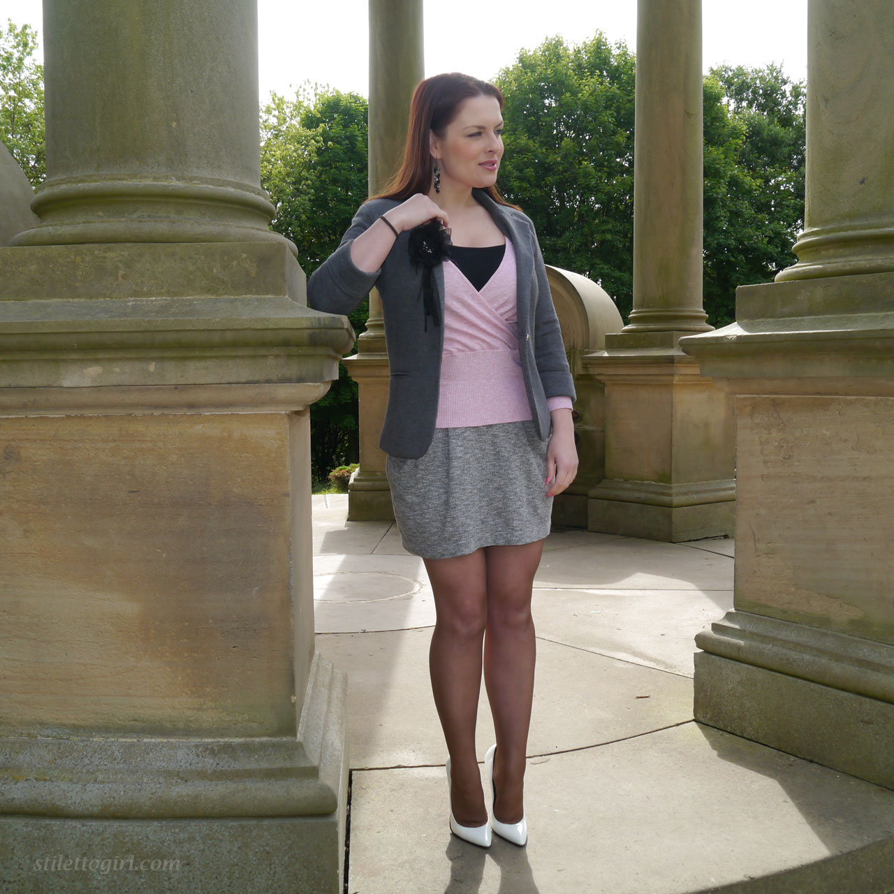 Redhead model showcases her hot legs in a short skirt and high heels