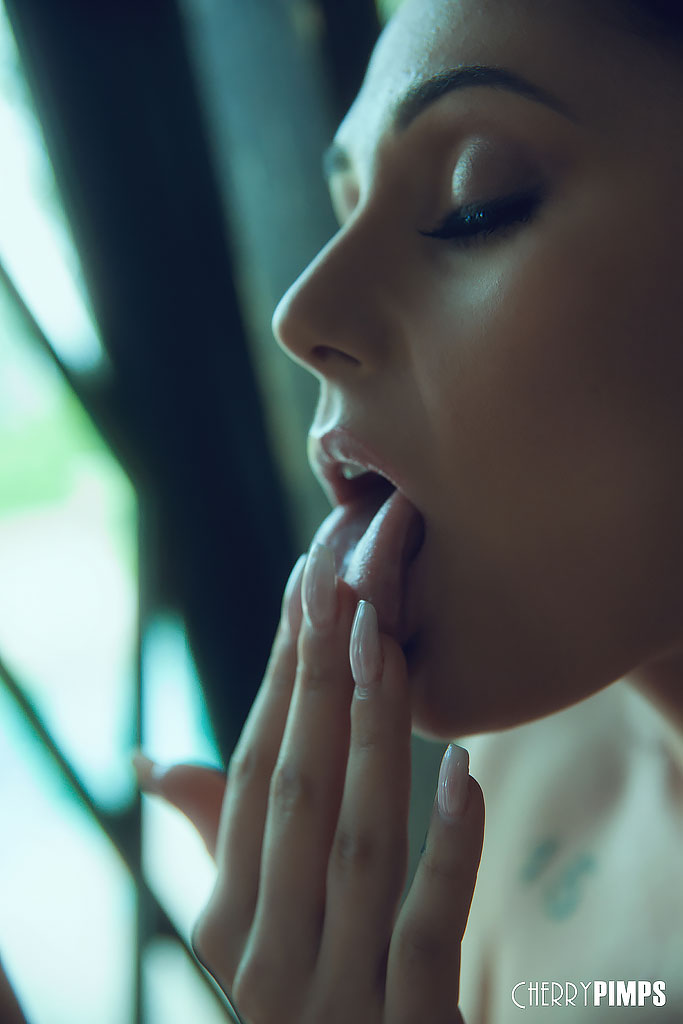 Solo girl Ariana Marie removes her shorts to get at her horny pussy