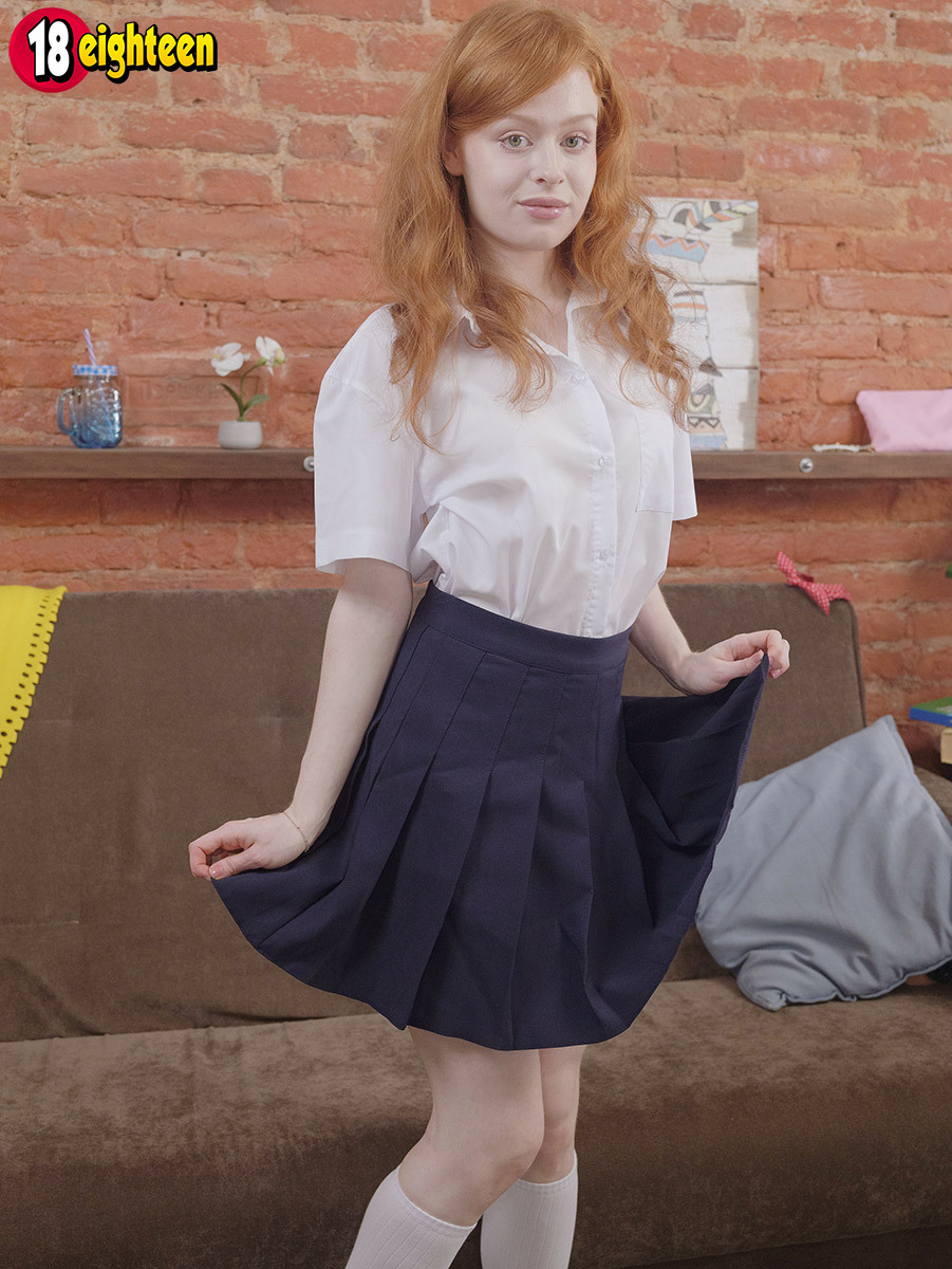 Young redhead removes her uniform to toy her pussy in white knee-high socks