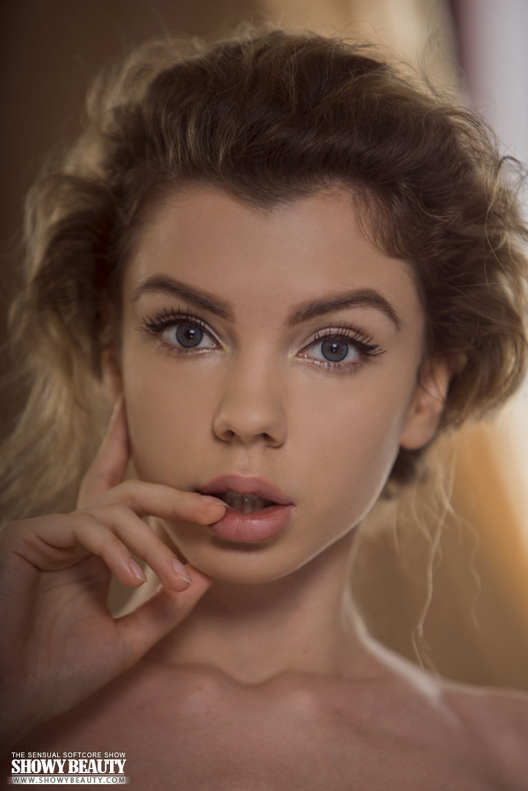 Skinny teen Inga poses totally naked on top of her bed