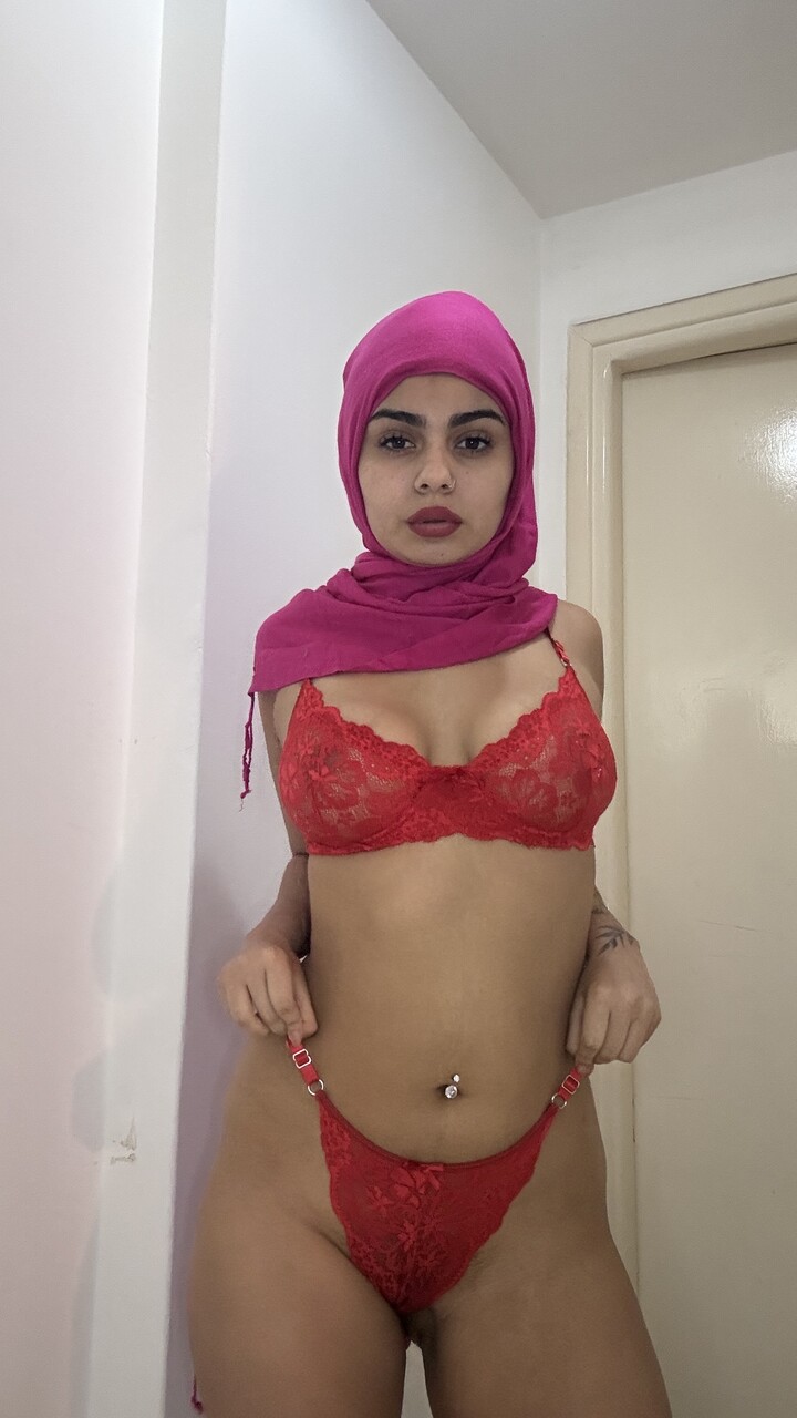 Solo girl with a big butt models lingerie while wearing a hijab