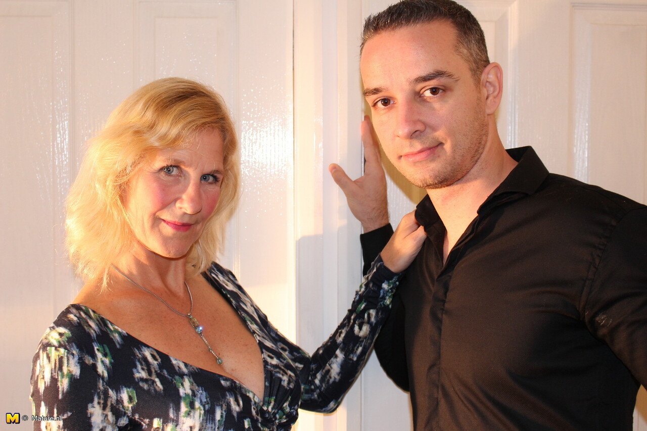 Mature blonde woman exposes her boobs while seducing a younger man