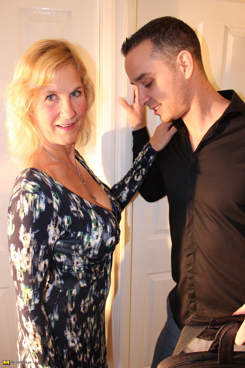 Mature blonde woman exposes her boobs while seducing a younger man