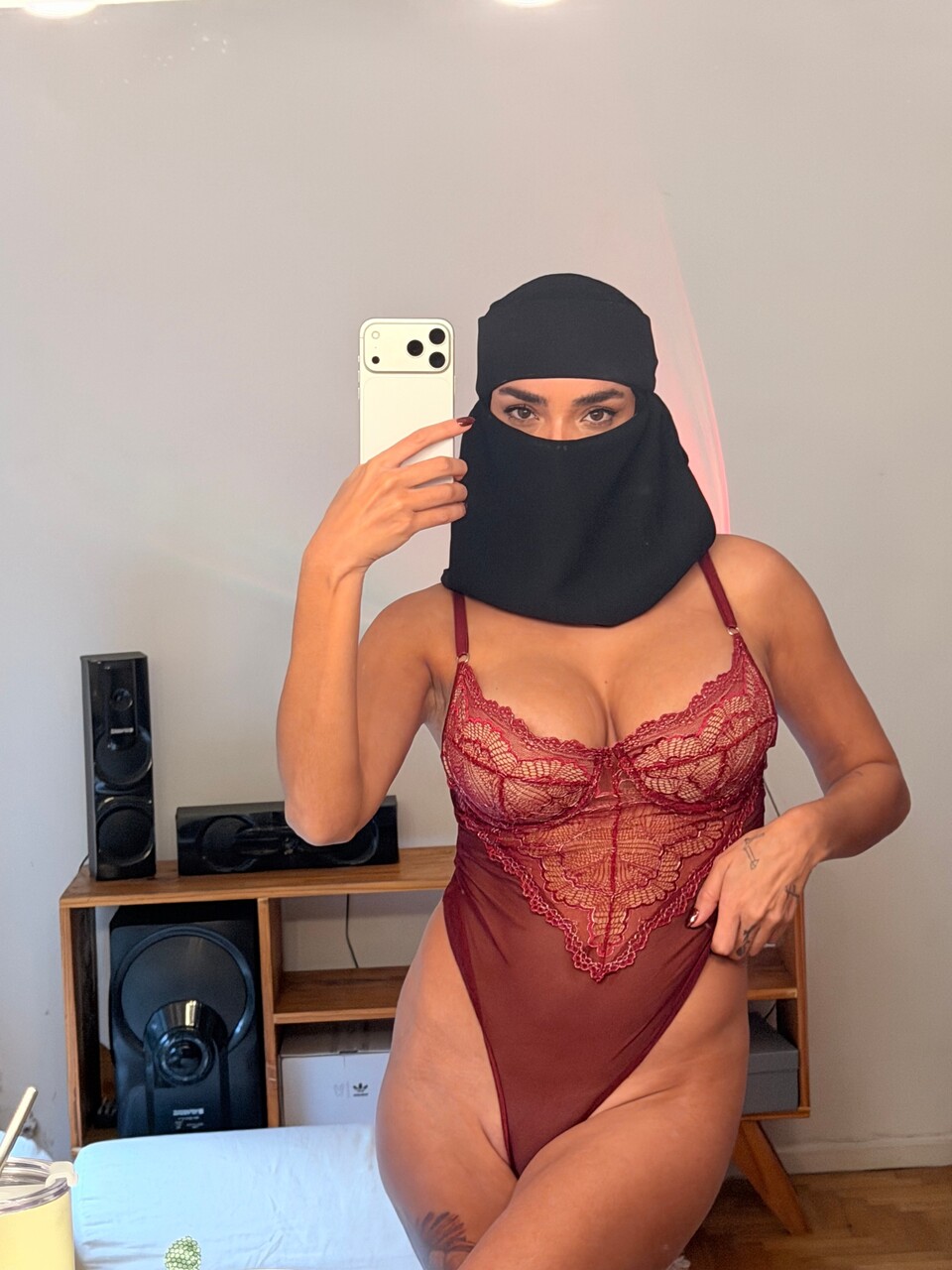 Solo girl takes selfies while wearing a bodystocking and ski mask