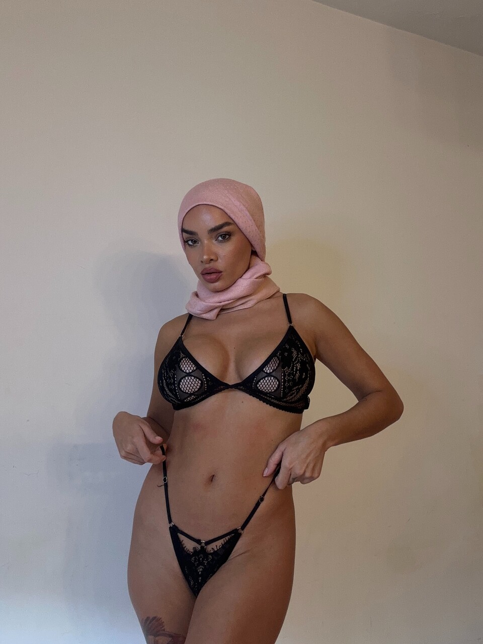 Solo girl takes selfies while wearing a black bodystocking and lingerie