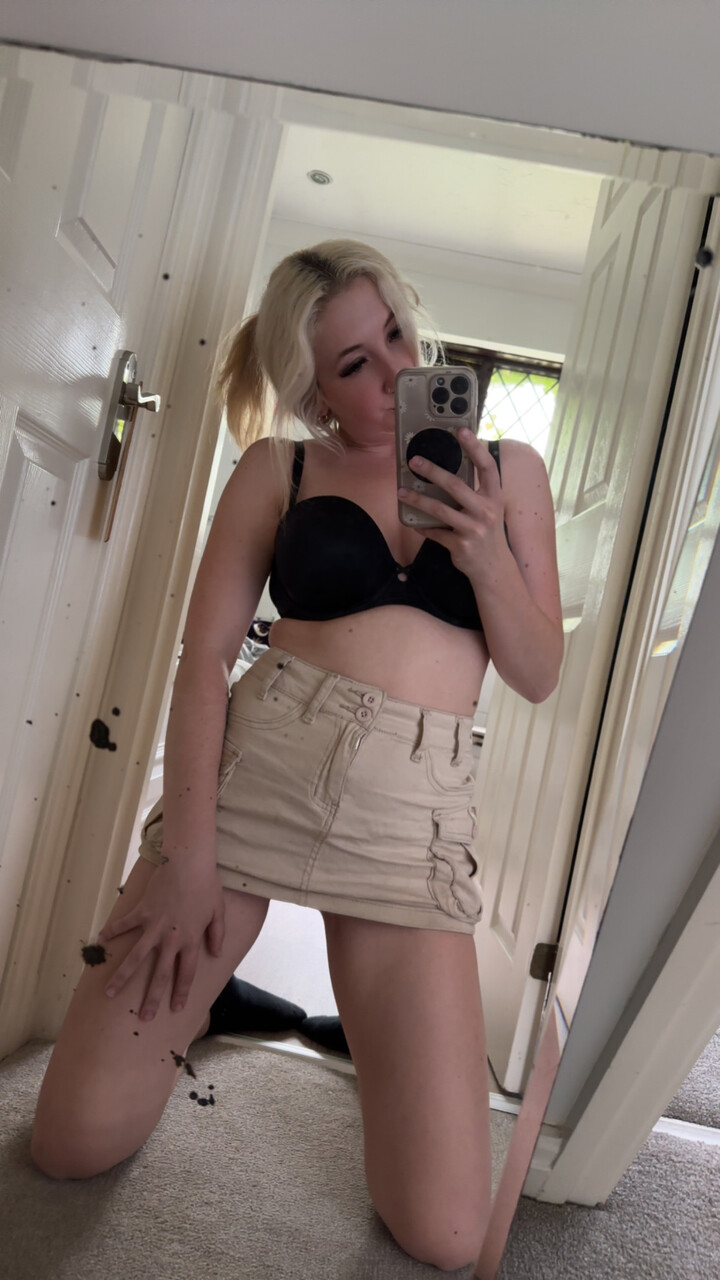 Dirty blonde takes selfies while wearing black panties and a mini skirt