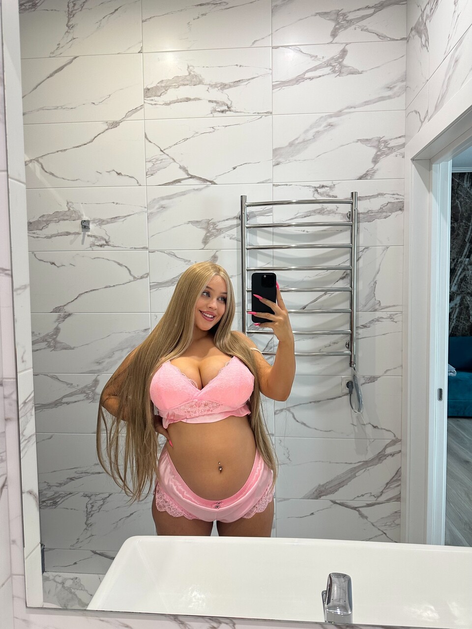 Pregnant solo girl takes selfies in a pink brassiere and plaid panties