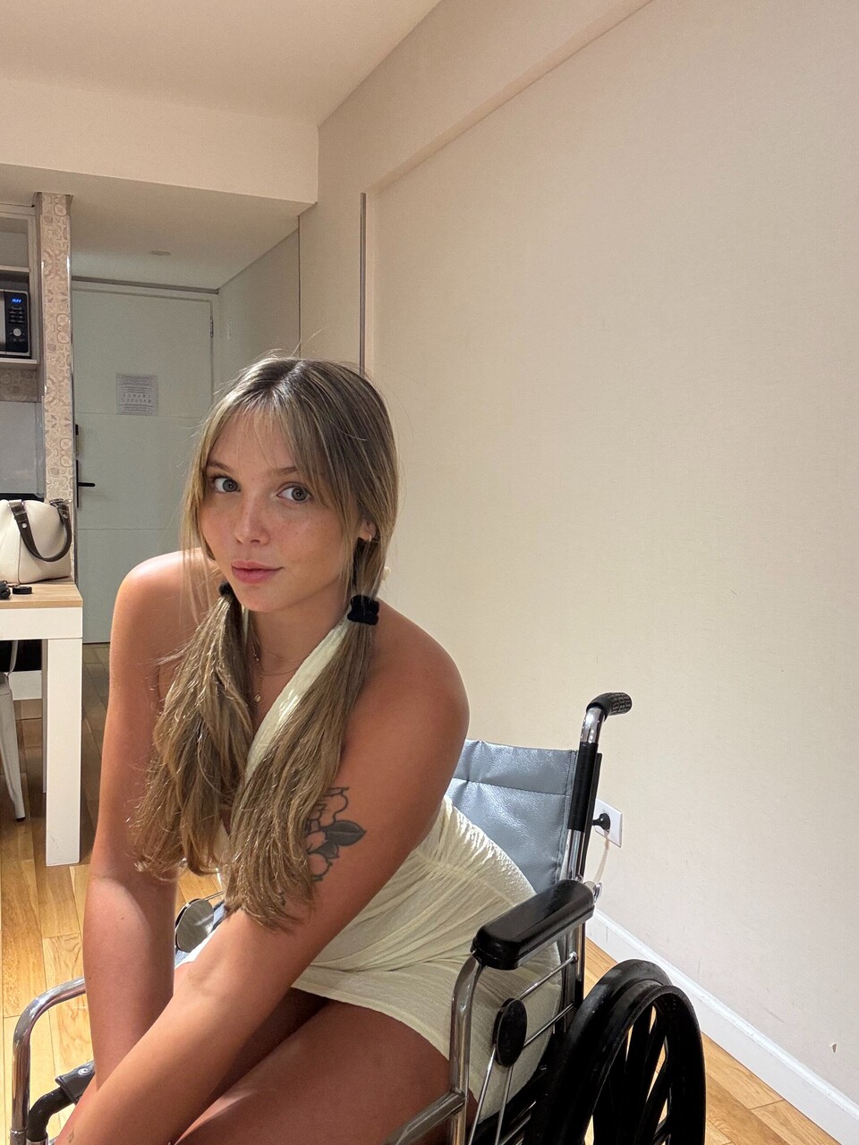 Young blonde removes a thong from her tight dress while in a wheelchair