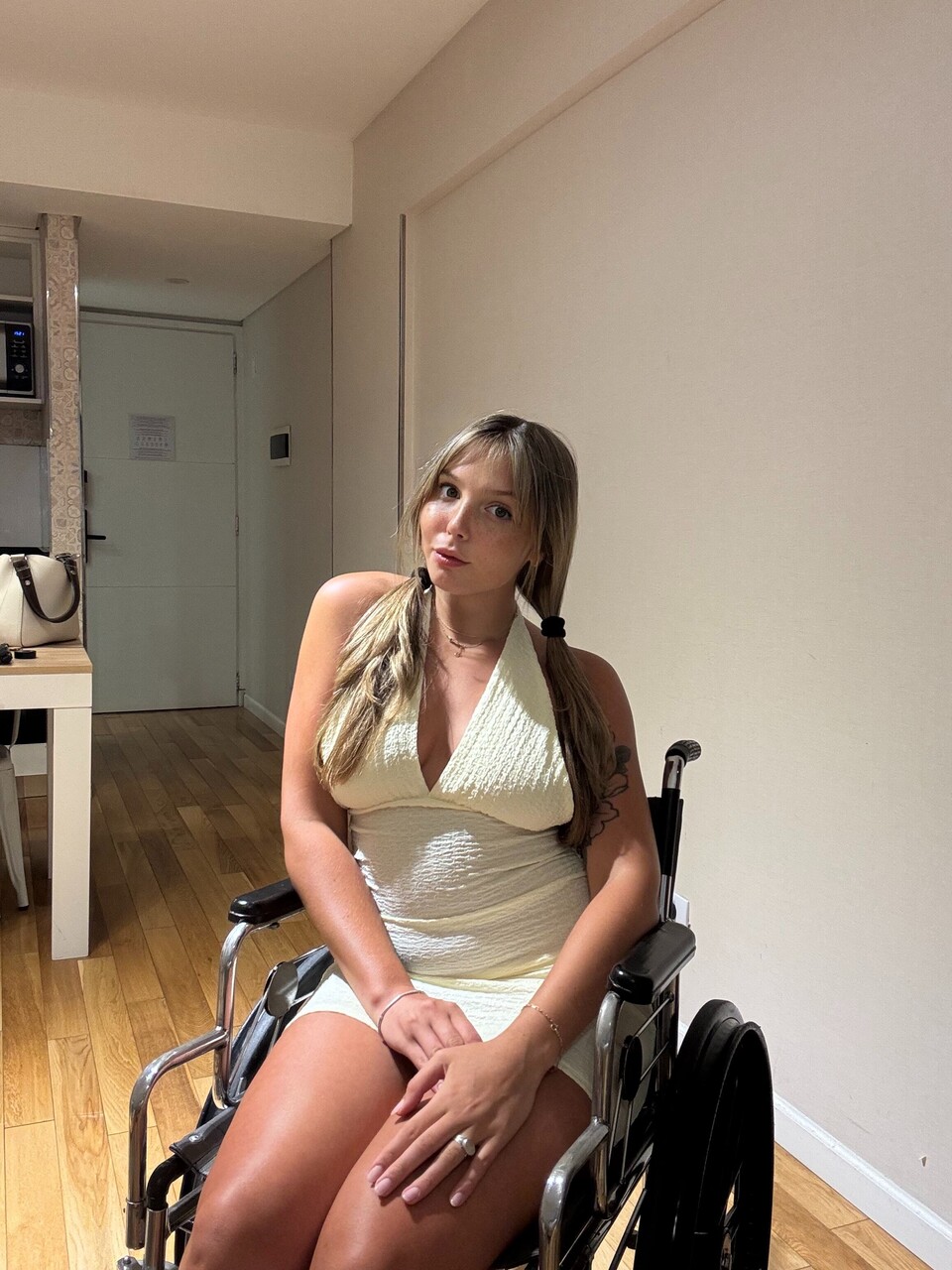 Young blonde removes a thong from her tight dress while in a wheelchair