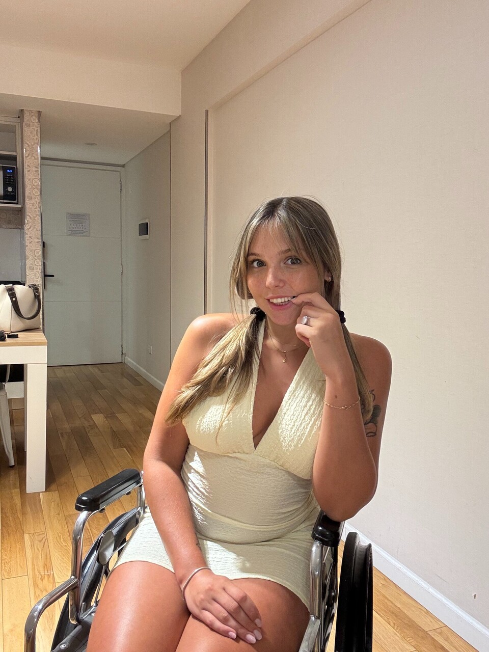 Young blonde removes a thong from her tight dress while in a wheelchair