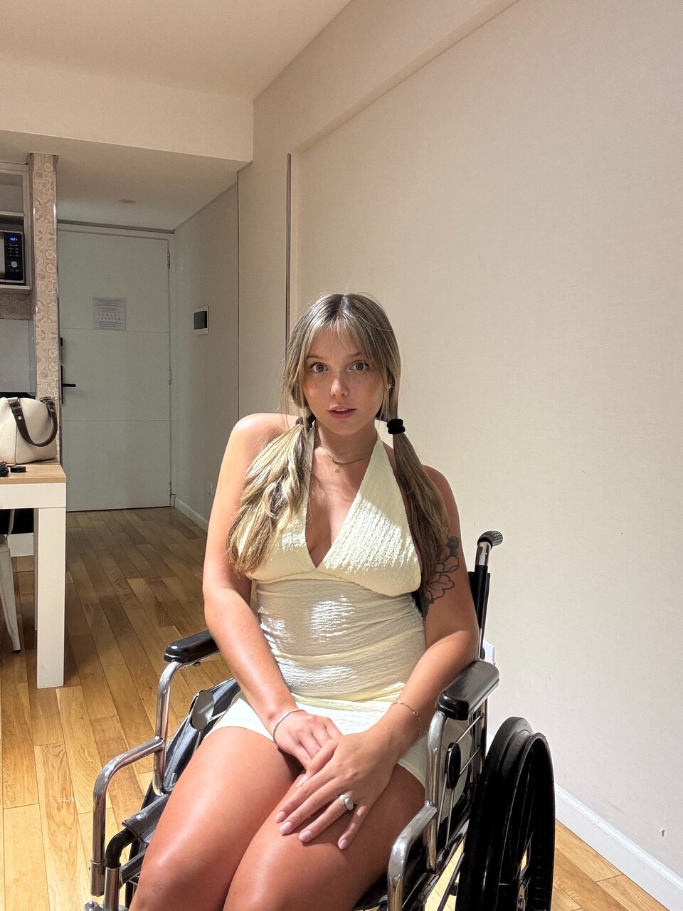 Young blonde removes a thong from her tight dress while in a wheelchair