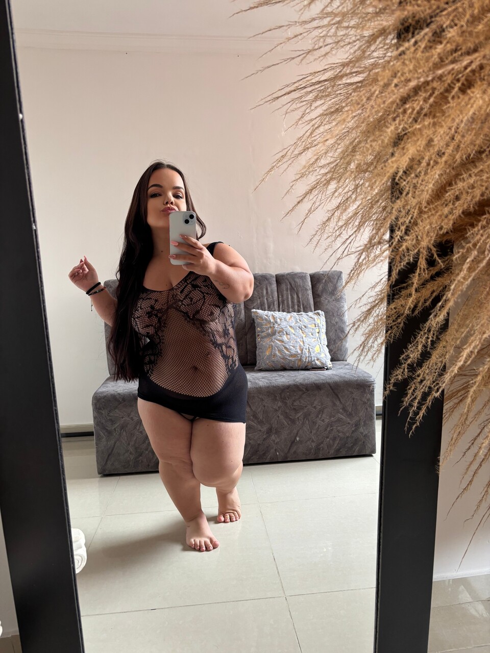 Solo girl with long dark hair and a phat ass takes selfies in a mirror