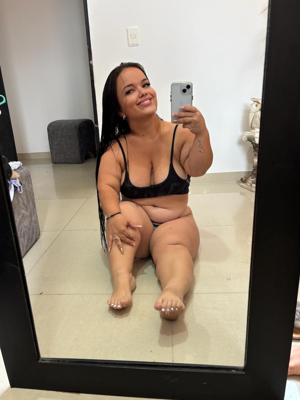 Chubby Latina teen takes selfies while wearing a black sports bra and thong