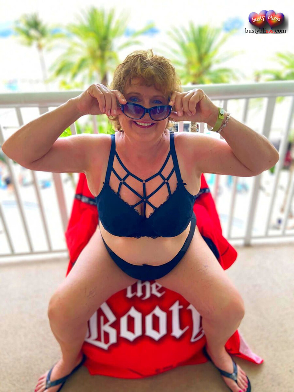 Mature woman Busty Bliss exposes her tits and butt on a balcony
