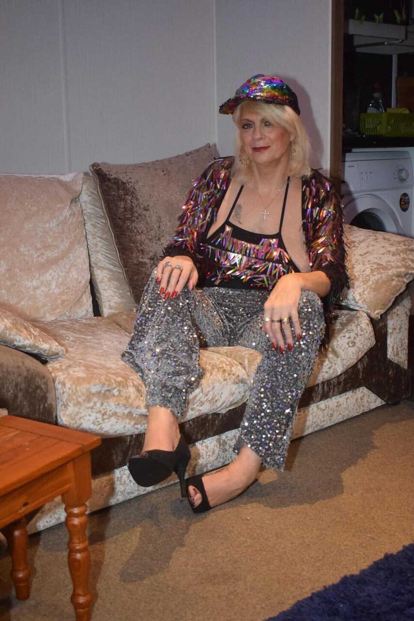 Older blonde Dimonty uncovers her natural tits while wearing a cap
