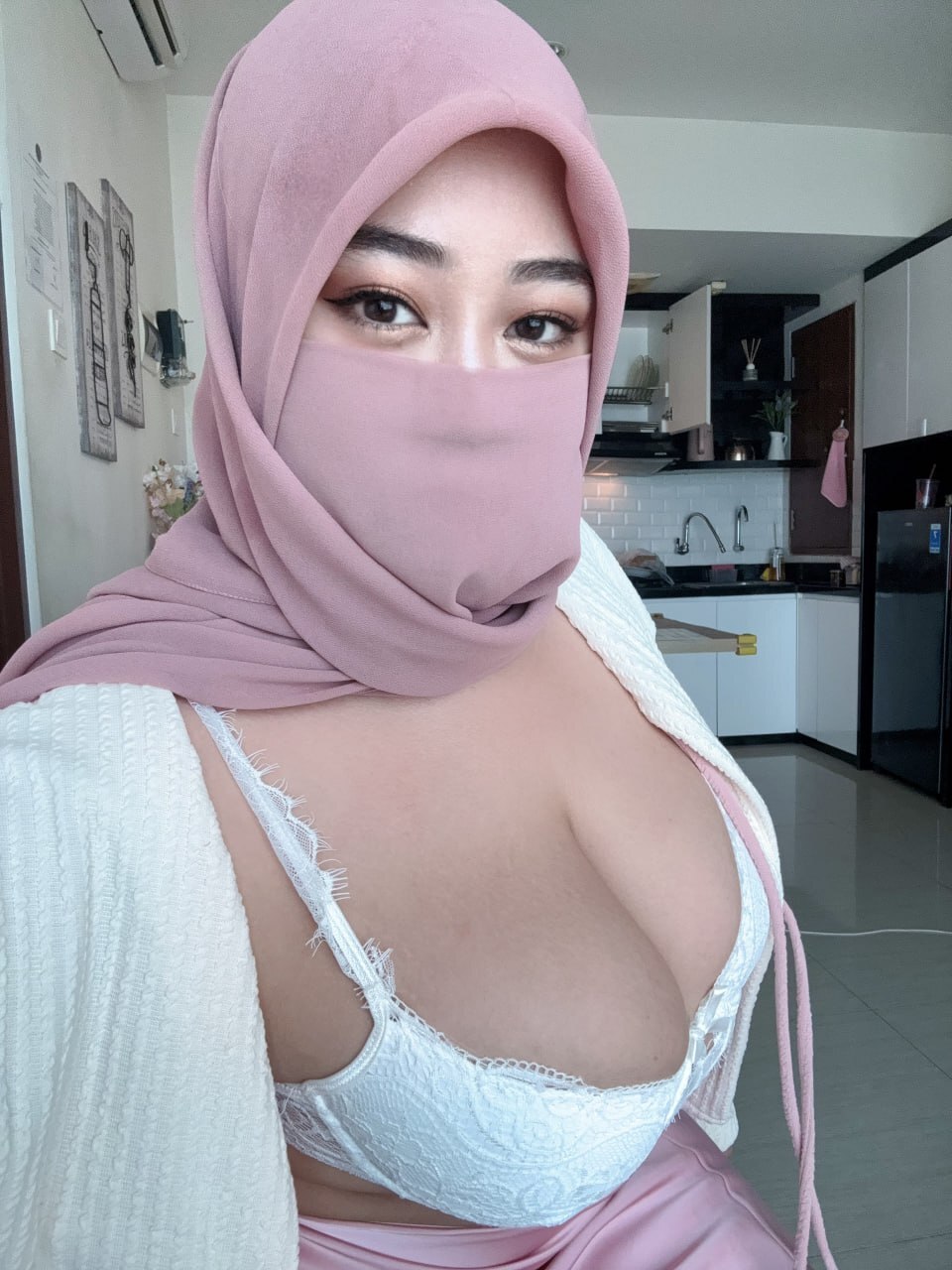 Solo girl releases her huge tits from her bra while wearing a hijab
