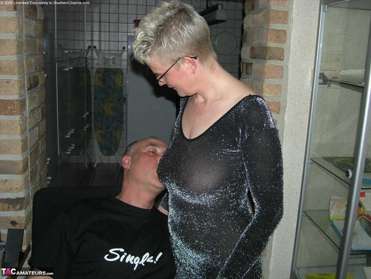 Mature woman Tiffany Pearl seduces a younger man in a black dress