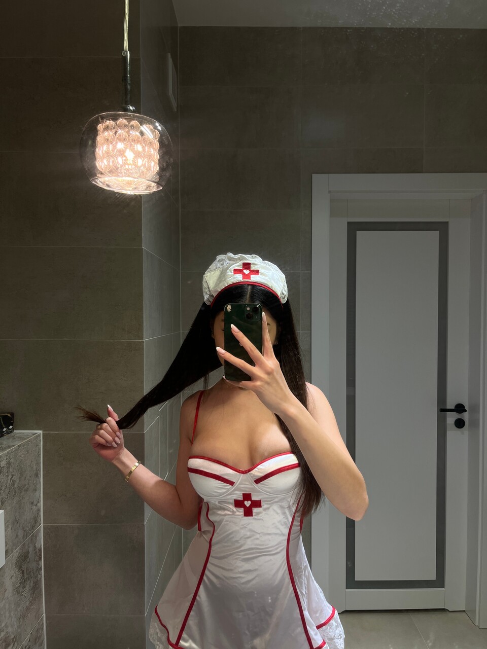 Asian chick takes selfies while wearing naughty nurse apparel