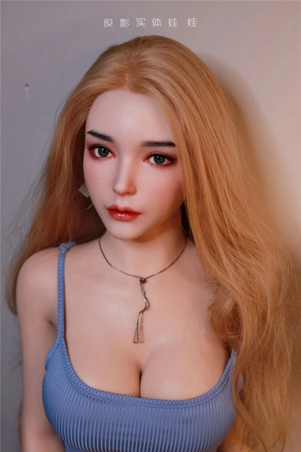 Pretty sex doll with long hair and a sexy dress posed for the camera