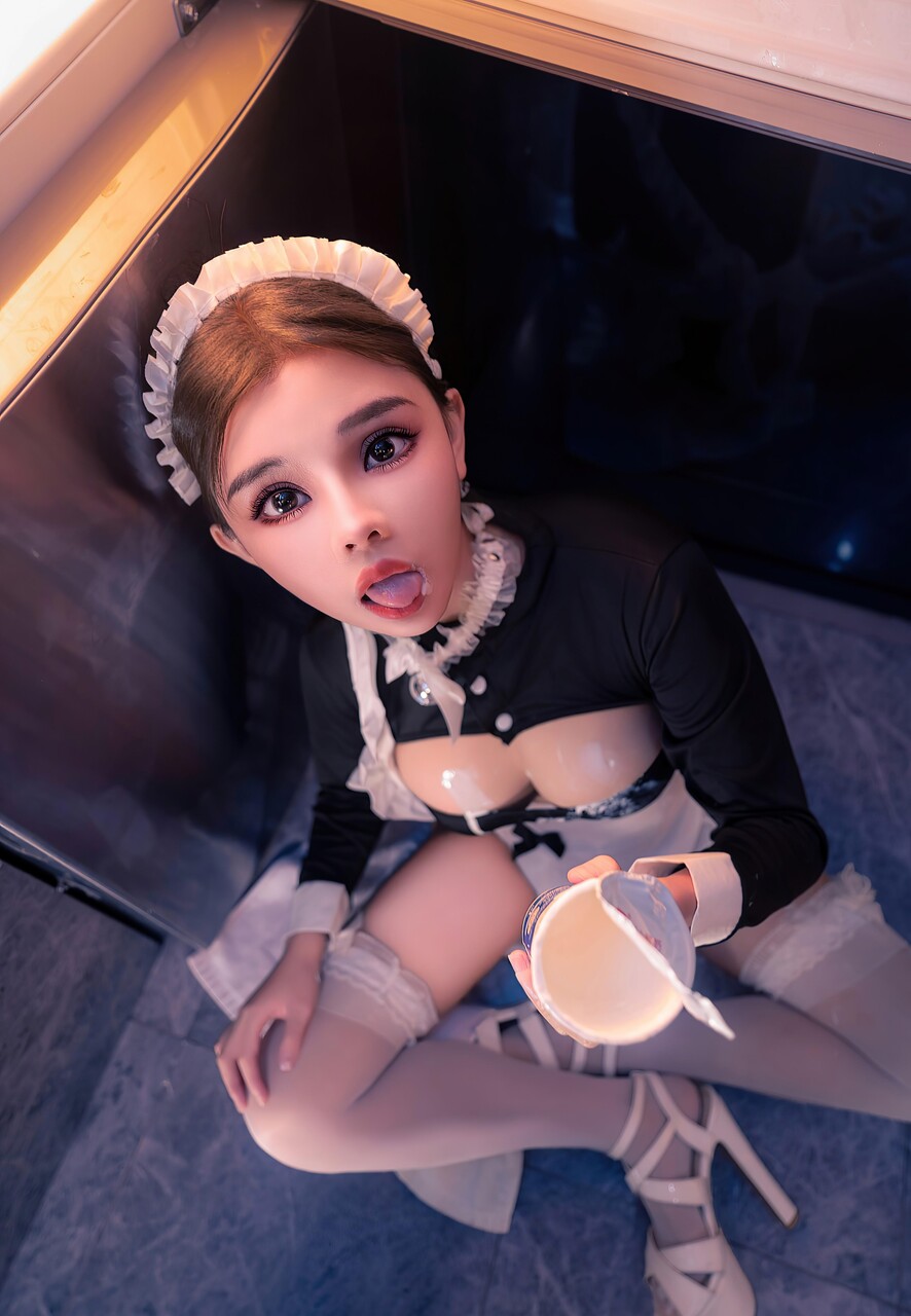 Beautiful Asian maid spills ice cream on herself while serving a cup