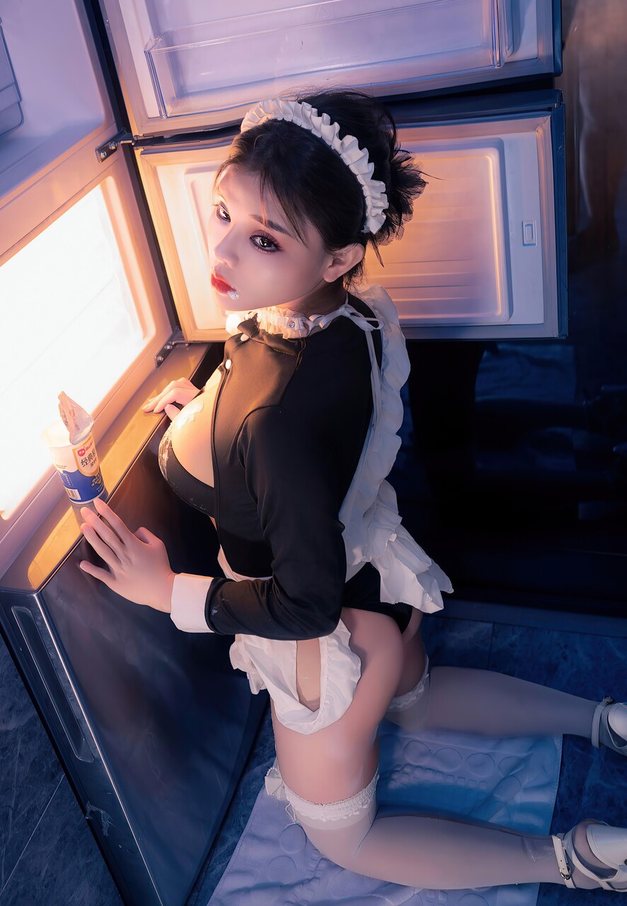 Beautiful Asian maid spills ice cream on herself while serving a cup